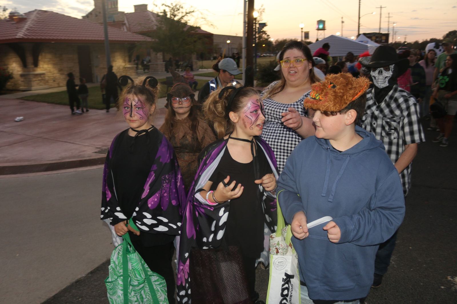 Children and adults wearing Halloween costumes in downtown Muskogee at a past Downtown Muskogee Halloween Boo-nanza