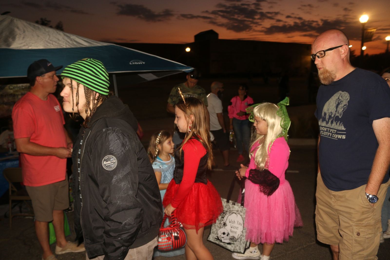 Families browsing the downtown Halloween festivities at dusk at a past Downtown Muskogee Halloween Boo-nanza
