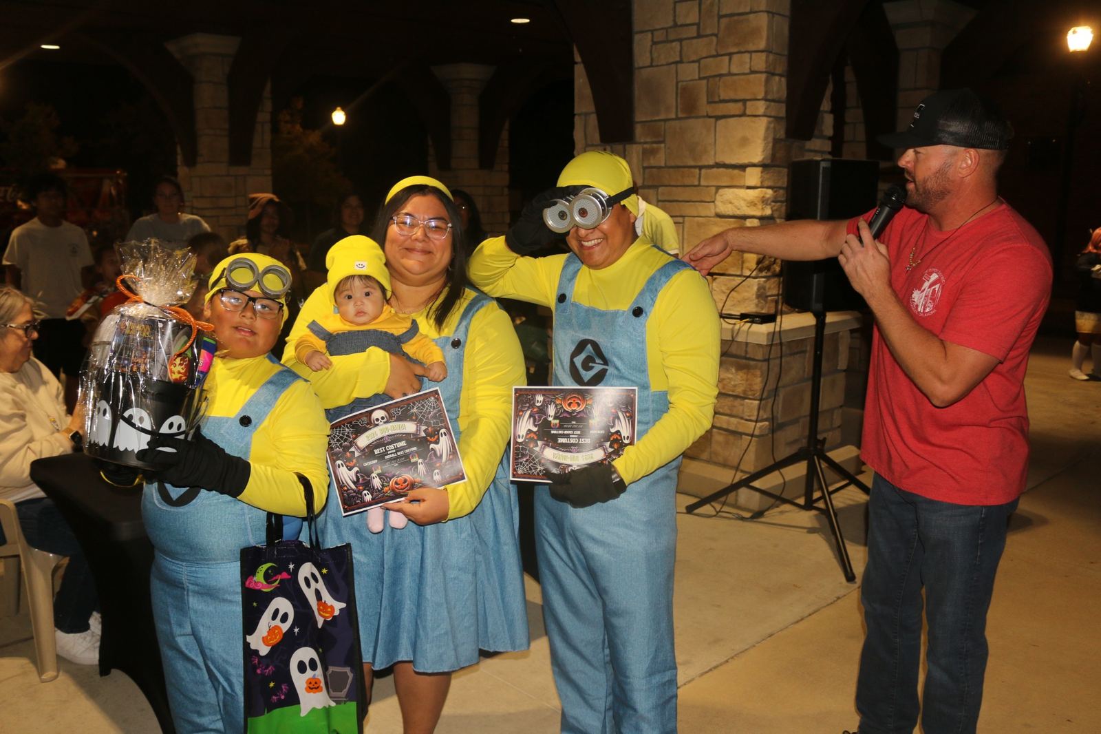 Family in matching yellow costumes receives recognition at a Halloween costume event at a past Downtown Muskogee Halloween Boo-nanza